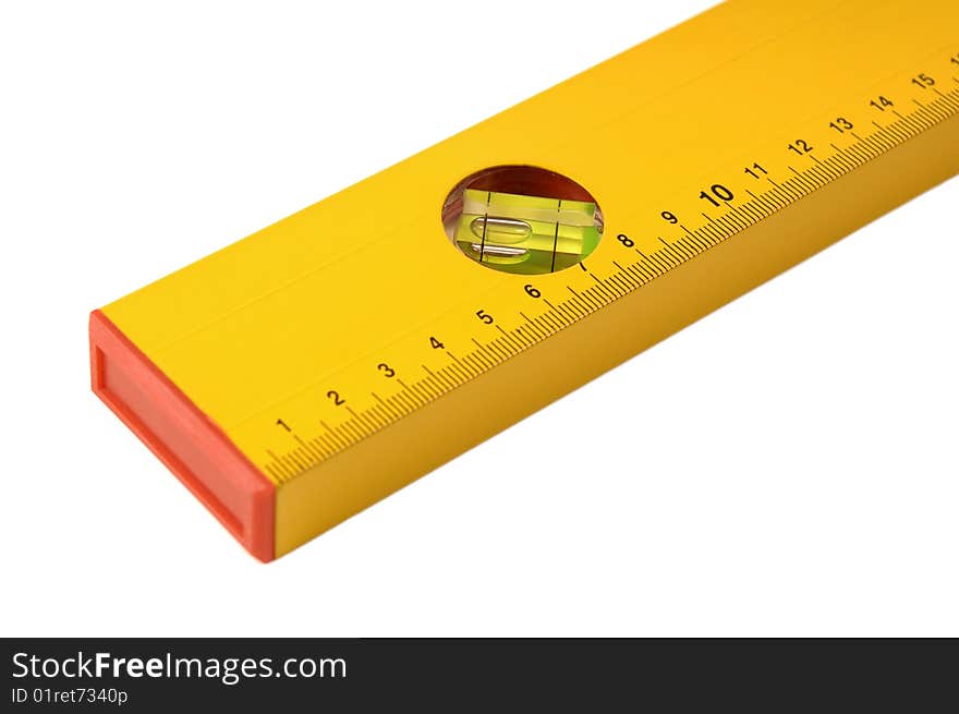 Part of a yellow ruler with level on a white background