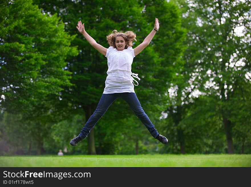 The girl jumps and smiles. The girl jumps and smiles