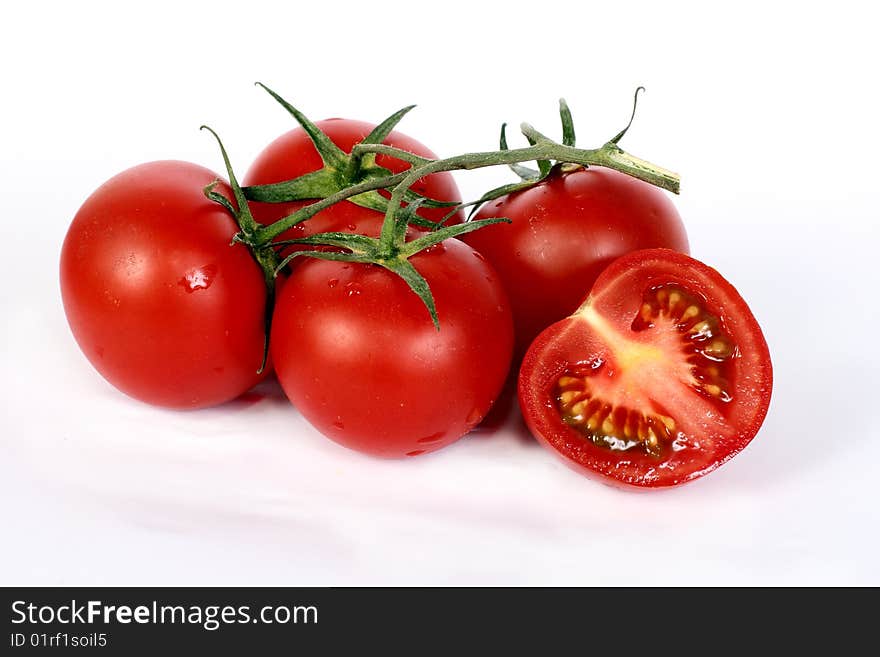 Some juicy red tomatoes on a white background. Some juicy red tomatoes on a white background