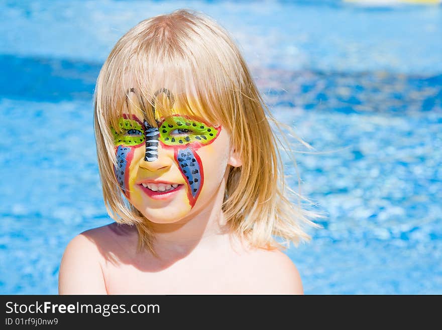 Girl with paint on his face in the pool. Girl with paint on his face in the pool