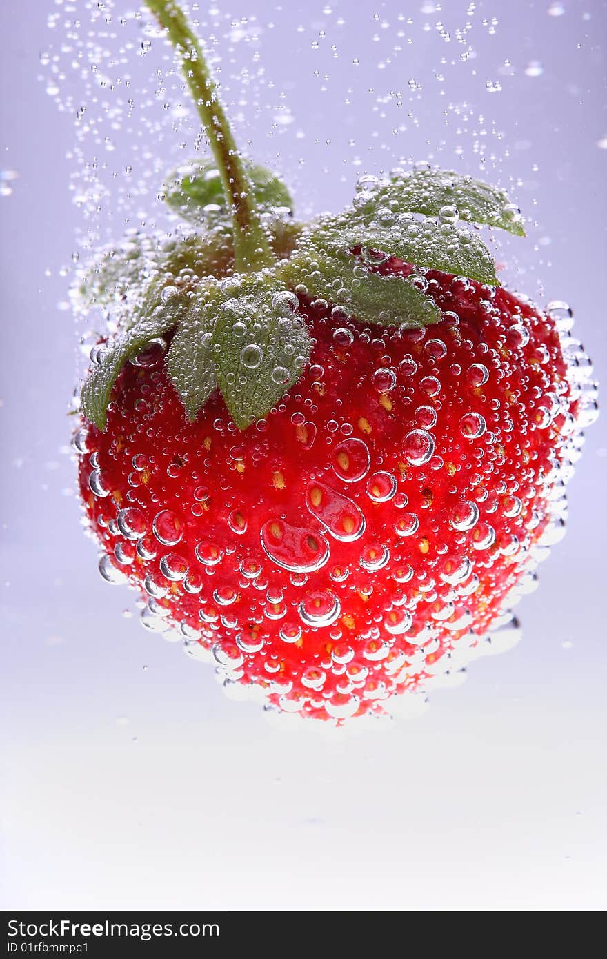 A strawberry submerged in water