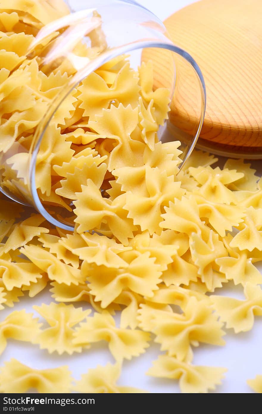 Farfalle pasta with glass isolated on white background