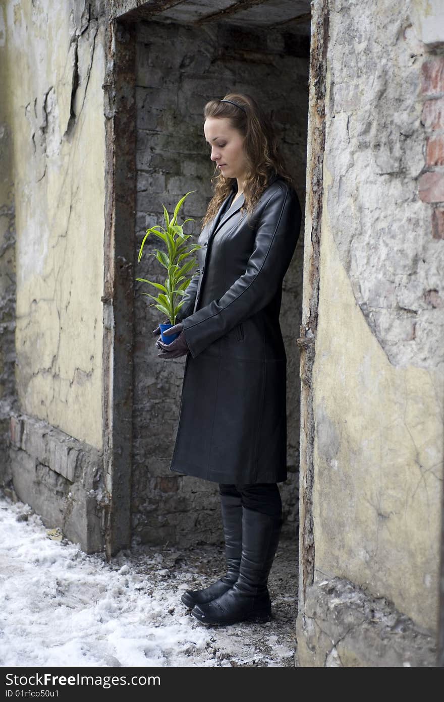 Girl being protecting the green plant. Girl being protecting the green plant