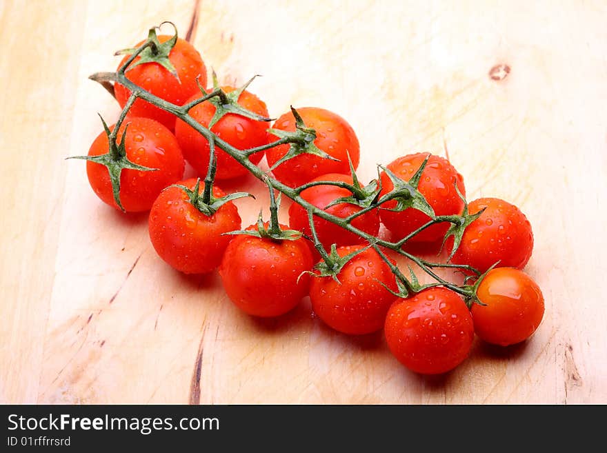 Cherry tomatoes on wooden cutting board