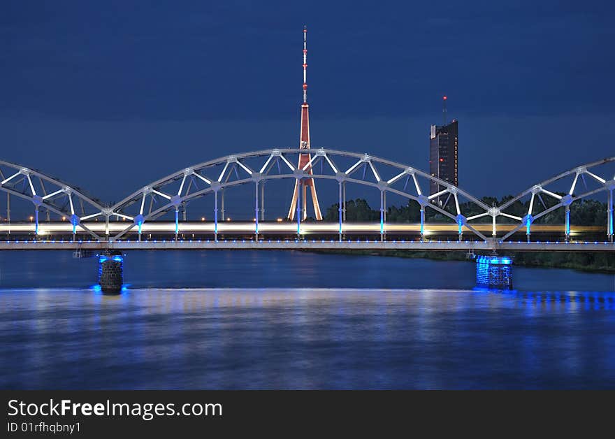 The night express train on the bridge across Daugava river. The night express train on the bridge across Daugava river.