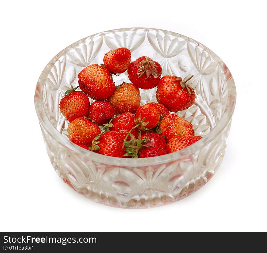 Glass bowl full of strawberries isolated on white bg. Glass bowl full of strawberries isolated on white bg