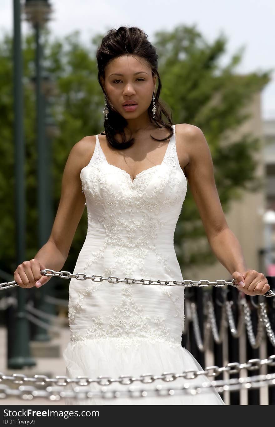 Great looking model in formal dress, posed with chains. Great looking model in formal dress, posed with chains.