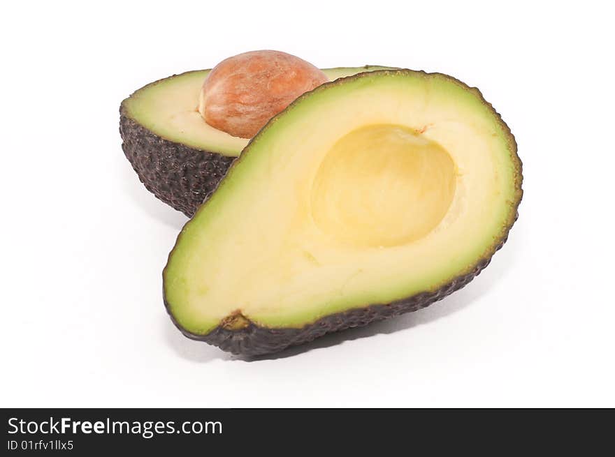 Avocado cut in half, with its stone/seed exposed.