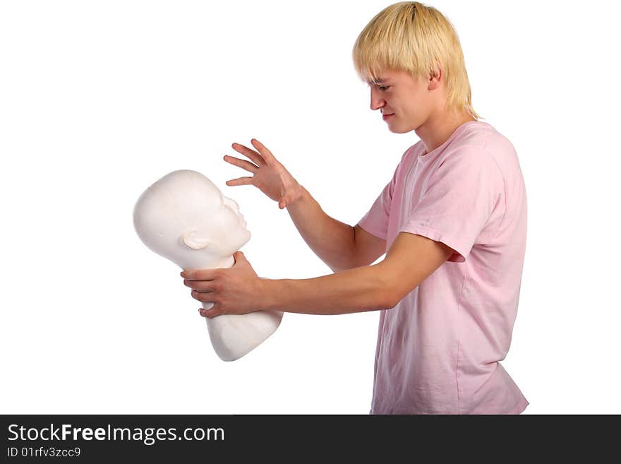 Young man in pink shirt holds gypsum head. Isolated