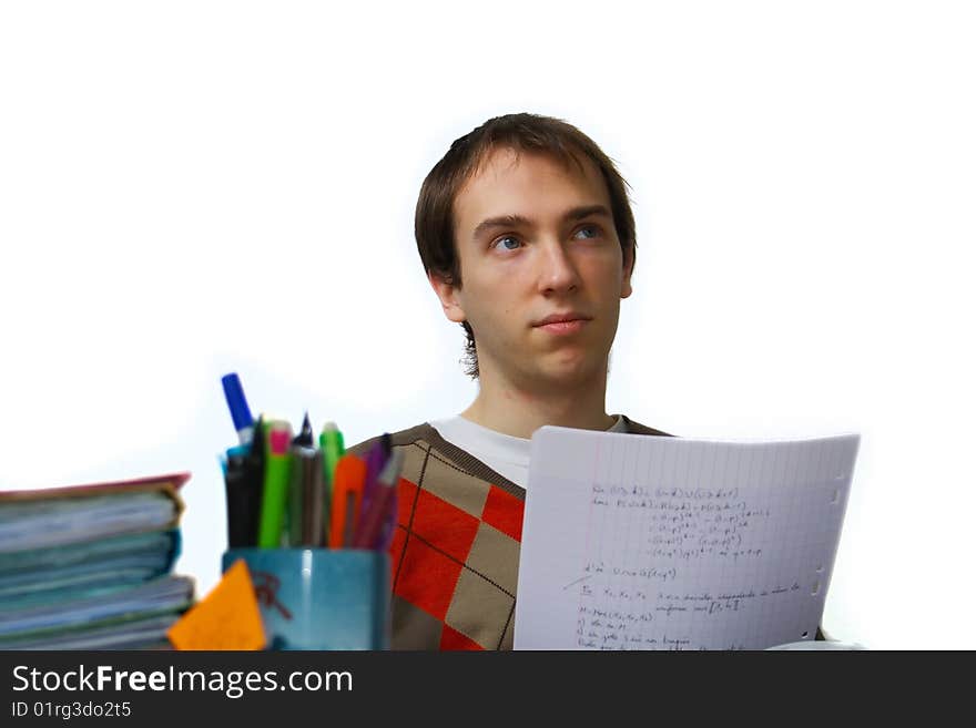 Male student at a table daydreaming. Male student at a table daydreaming