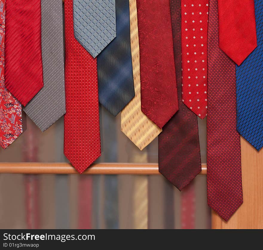 Male ties hung on door