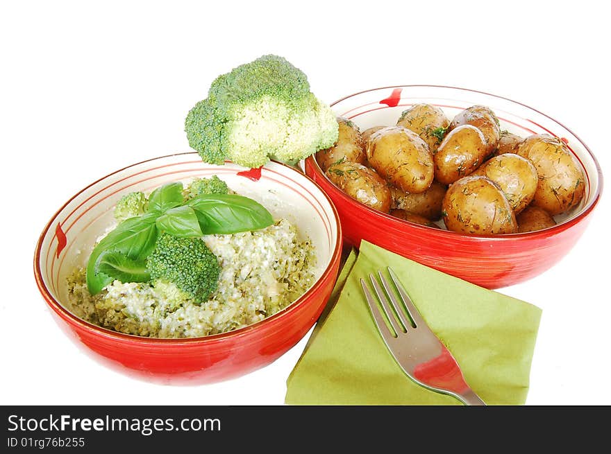 Vegetables for lunch in two red bowls