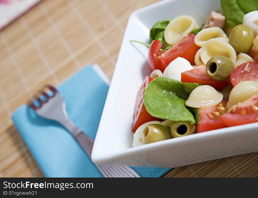 Healthy pasta with olives mozzarella and tomatoes