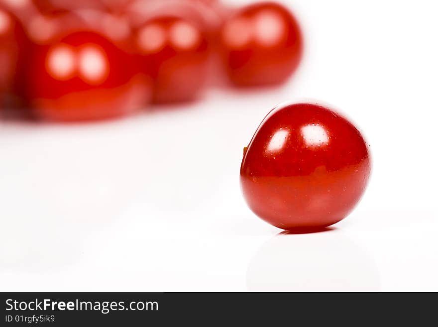 Red fresh sour cherries on white background