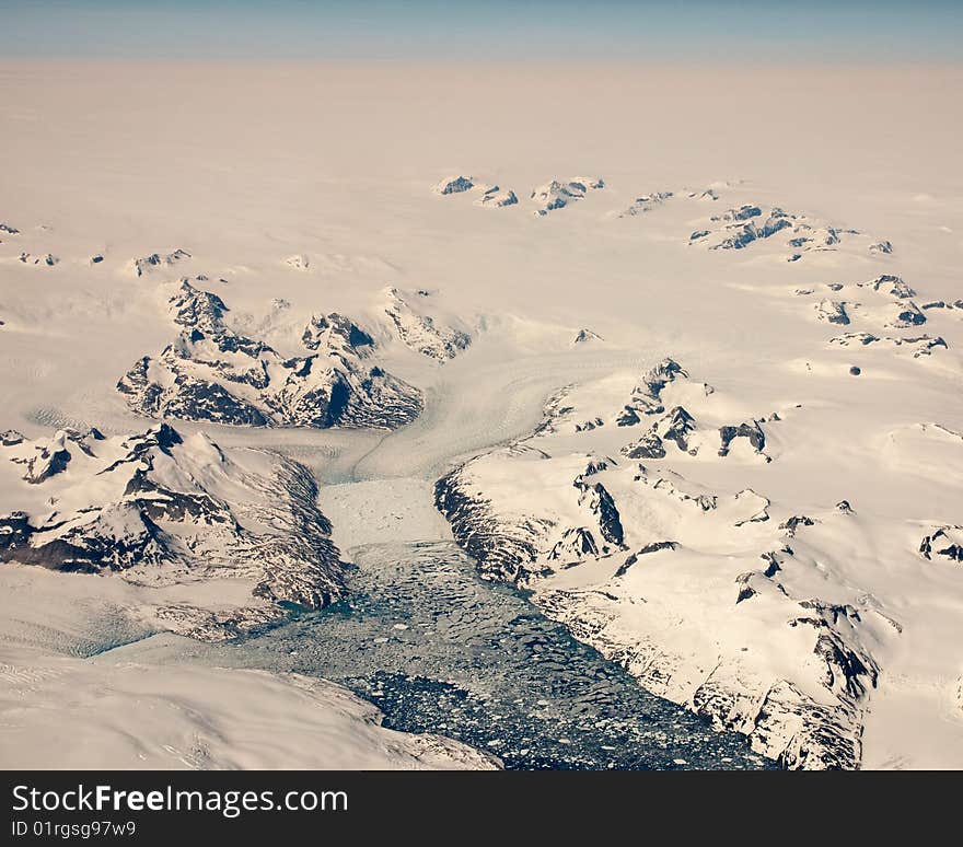 Aerial view of Glacier and Ice Floe taken at 39000 feet over Greenland. Aerial view of Glacier and Ice Floe taken at 39000 feet over Greenland.