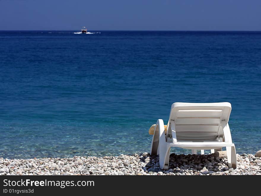 White sailboat floating on the blue sea