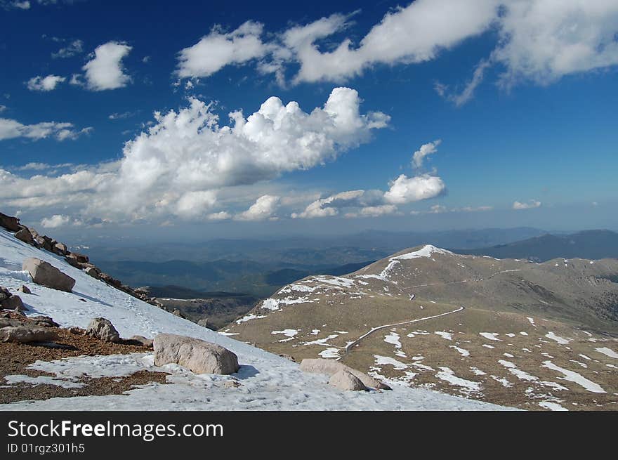 This is a view of the alpine section of Mt. Evans Road as seen from it's end at the base of the summit trail. Much of the Mt. Evan's Wilderness is seen on the horizon.