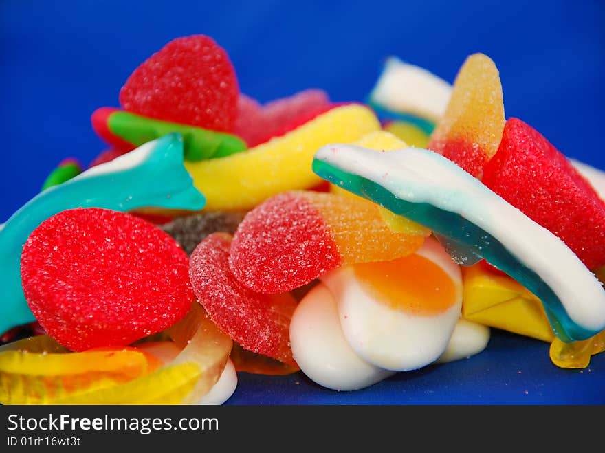 Close-up of an assortment of candies on a blue background. Close-up of an assortment of candies on a blue background