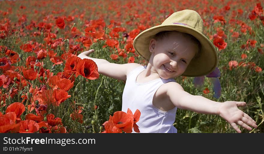 On the image there is a little girl. She is in field of flowers. On the image there is a little girl. She is in field of flowers.