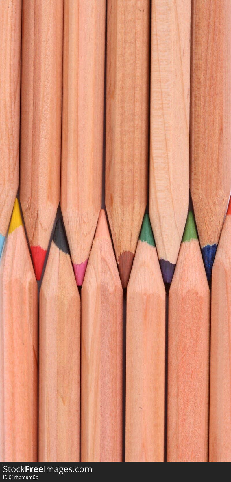 Wooden color pens lined up verticaly