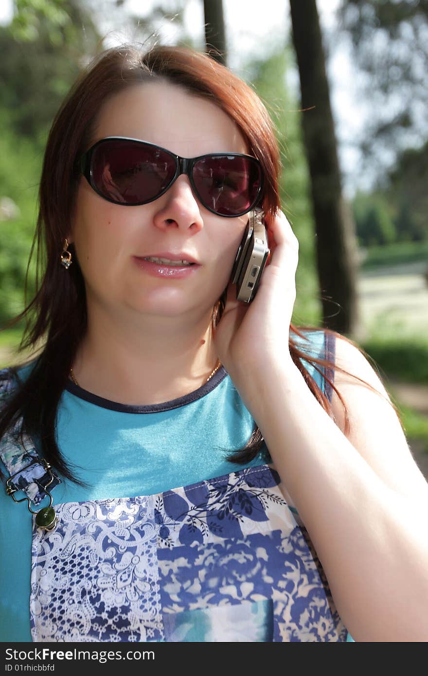 The young woman call in a park