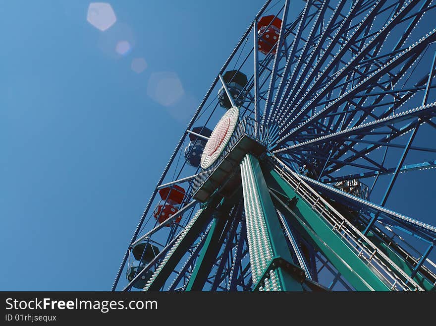 Colorful joy-wheel in the blue sky. Colorful joy-wheel in the blue sky