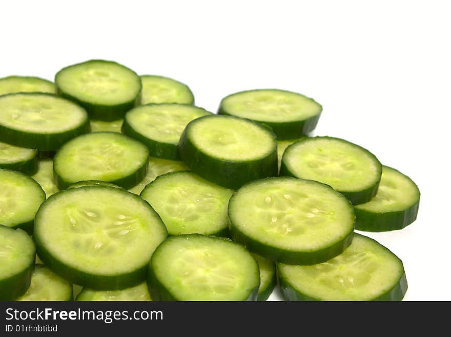 Background from slices of a cucumber on white. Background from slices of a cucumber on white