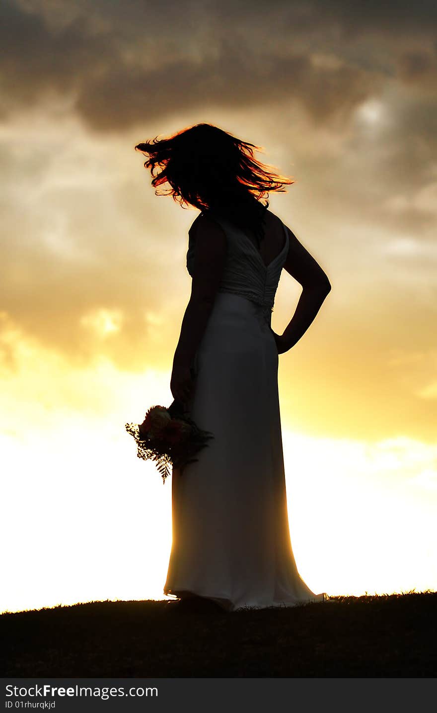 Fire-y hair bride silhouette during sunset. Fire-y hair bride silhouette during sunset