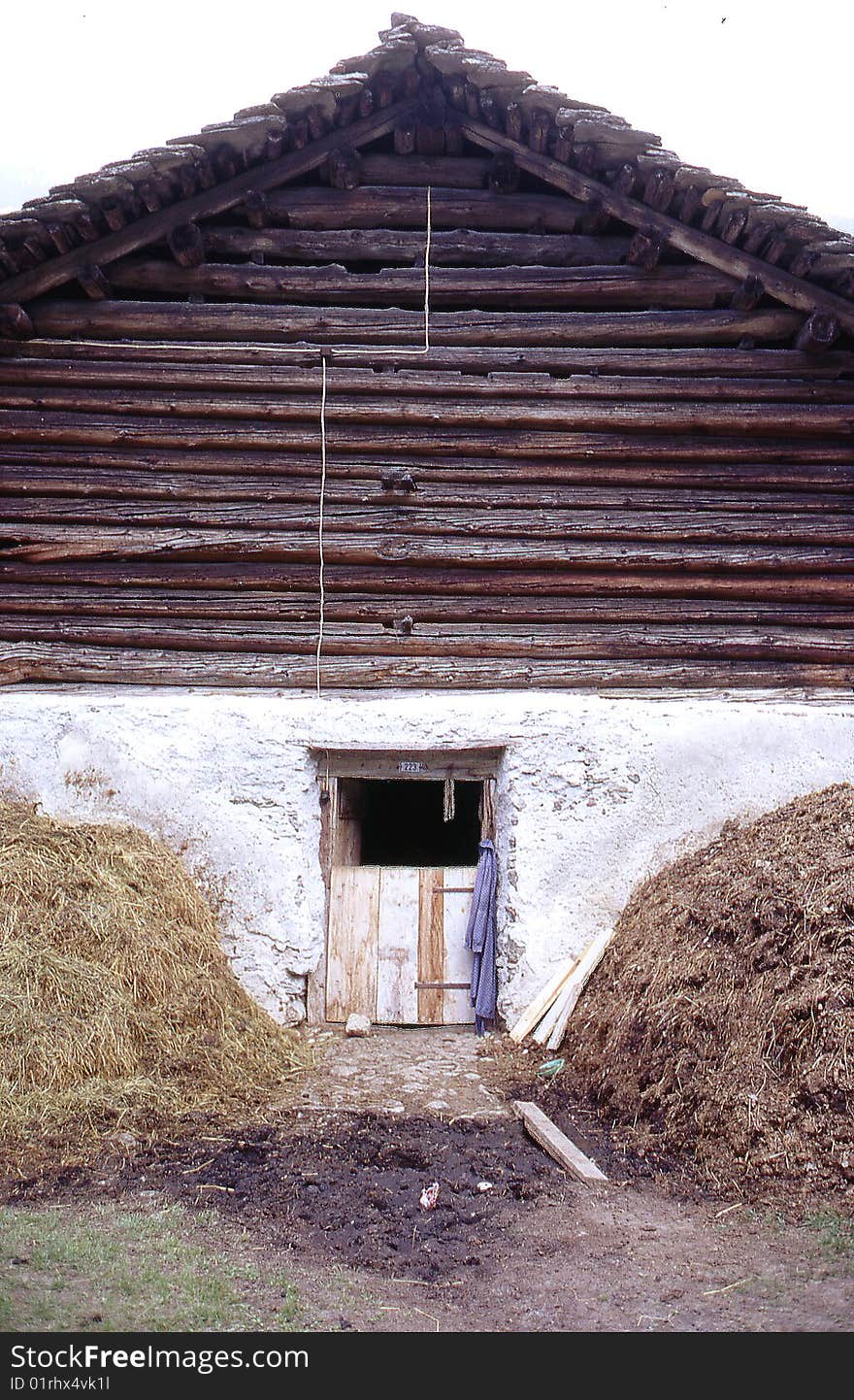 This photographs shows a barn house in Bernese Overland, Switzerland with two haystacks on either side. This photographs shows a barn house in Bernese Overland, Switzerland with two haystacks on either side.