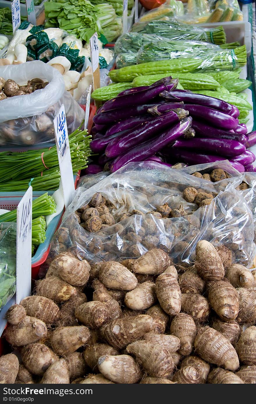 View of a street market's table with vegetables for sale.