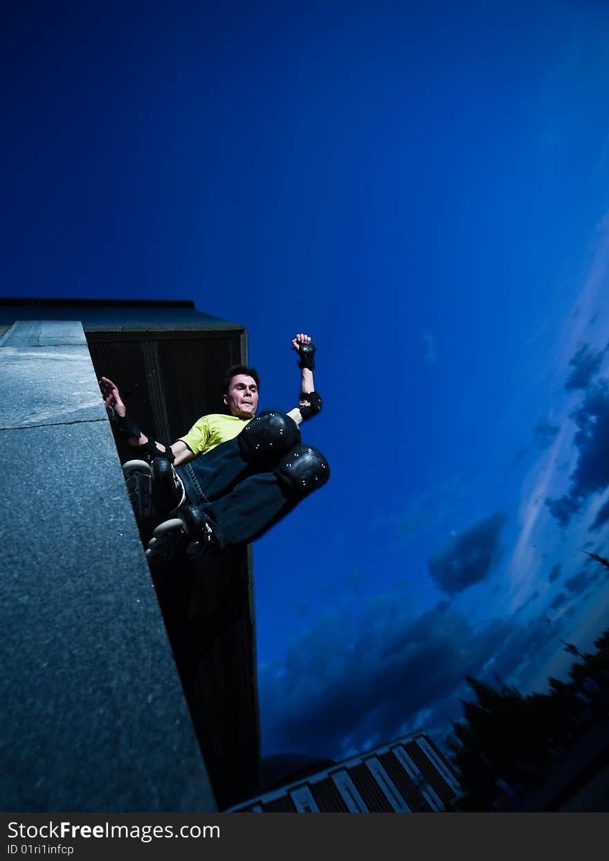 Wide angle photo of a roller performing wall-ride element - photo with a little natural motion blur. Wide angle photo of a roller performing wall-ride element - photo with a little natural motion blur