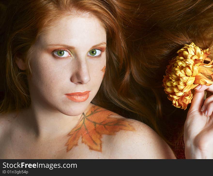 Beautiful girl with autumn style face-art make-up