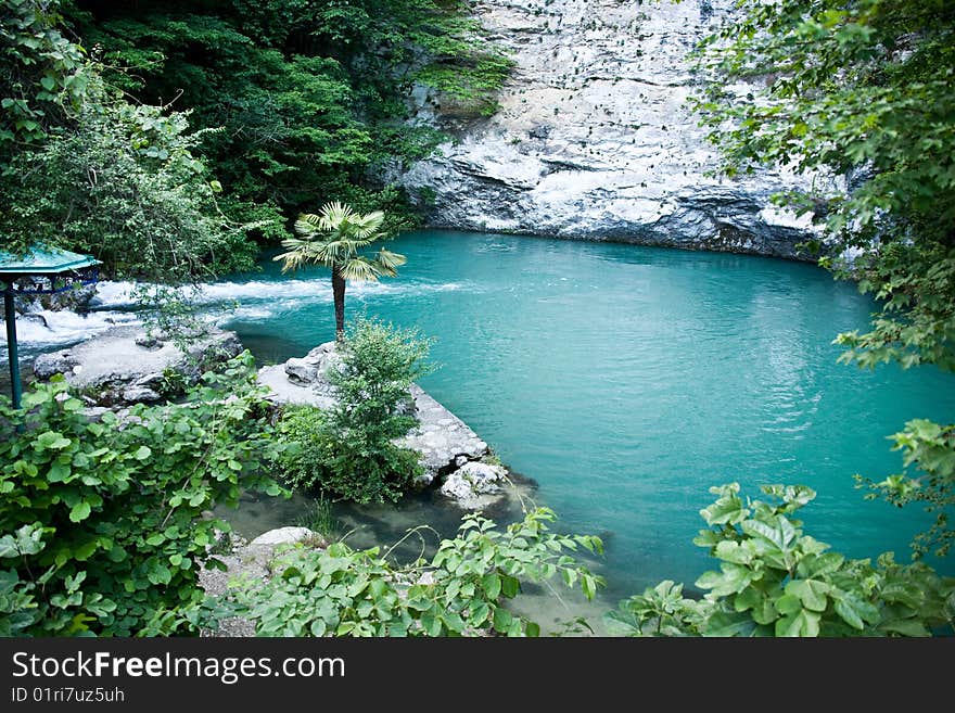 Small lake at a mountain foot. Blue lake. Abkhazia