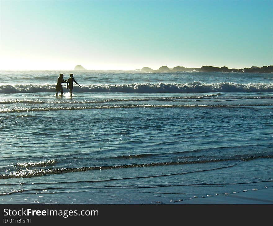 Two black men on Camps Bay beach, Cape Town. Two black men on Camps Bay beach, Cape Town.