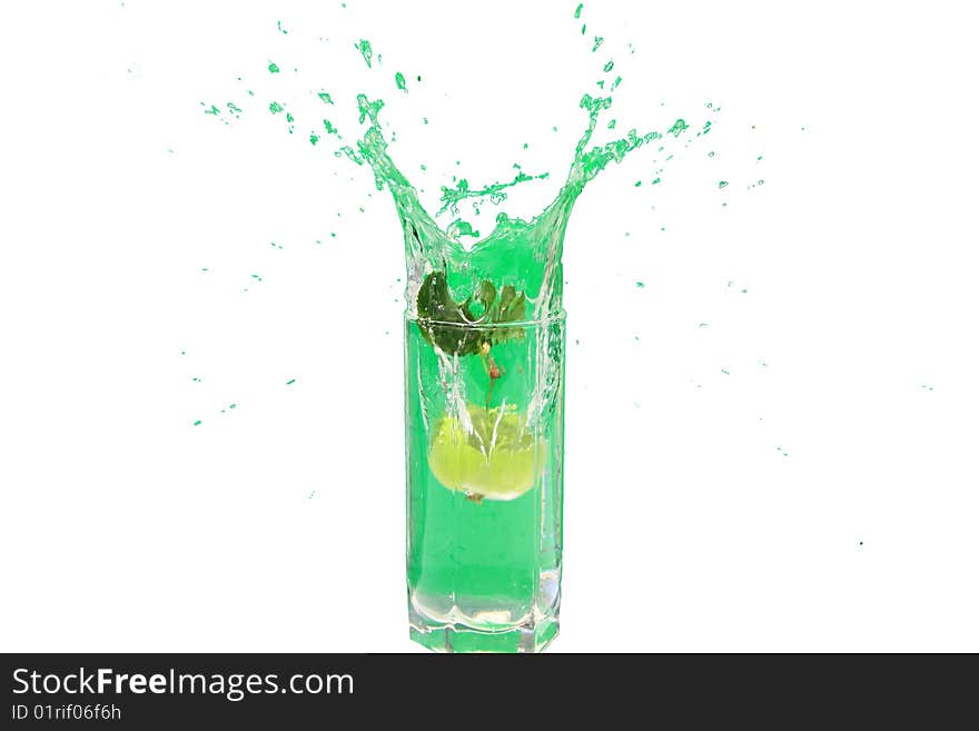 Green apple falls from a tree in a glass of water. Green apple falls from a tree in a glass of water