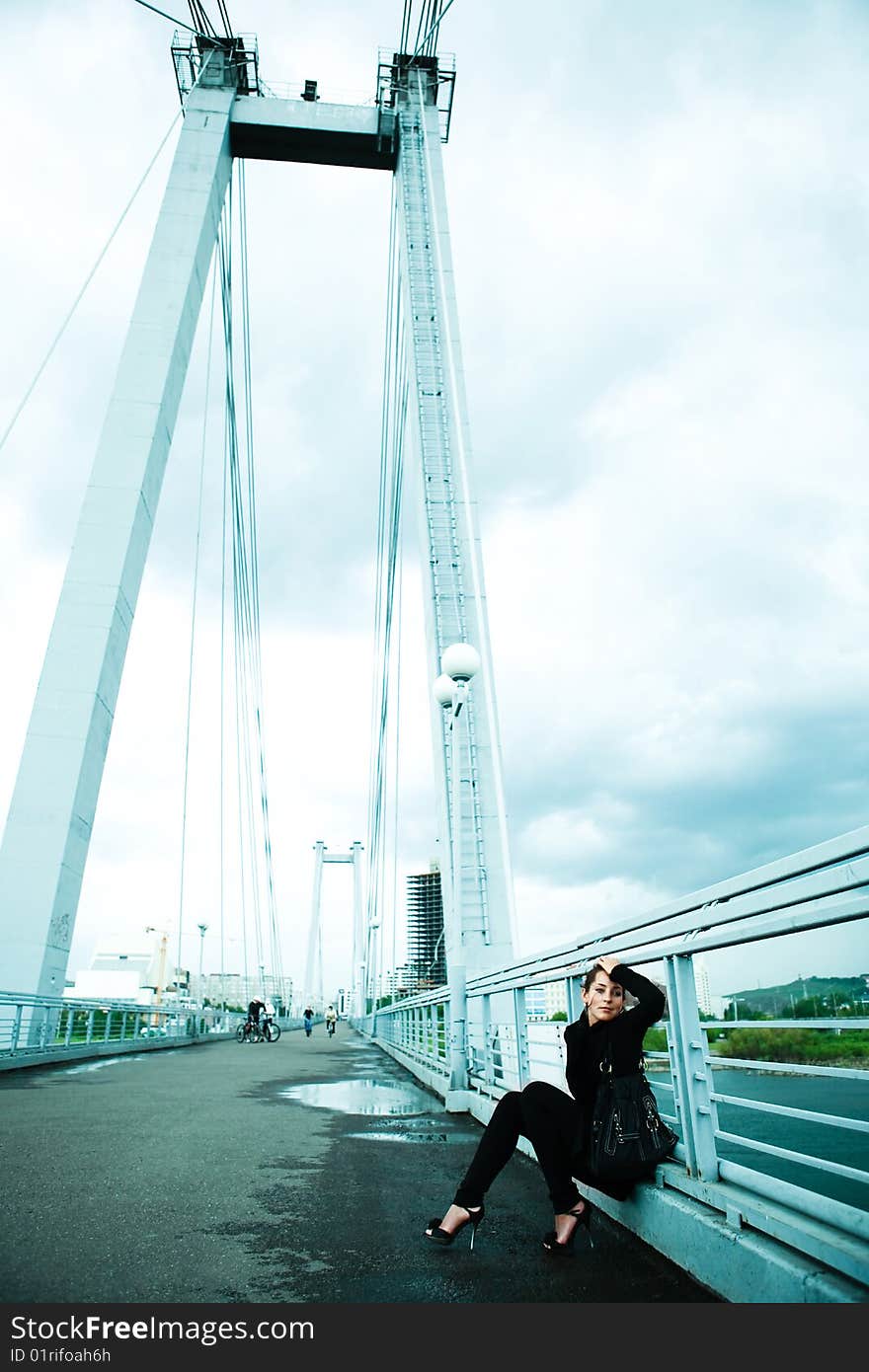 Lonely young woman on a rainy day on the bridge. Lonely young woman on a rainy day on the bridge