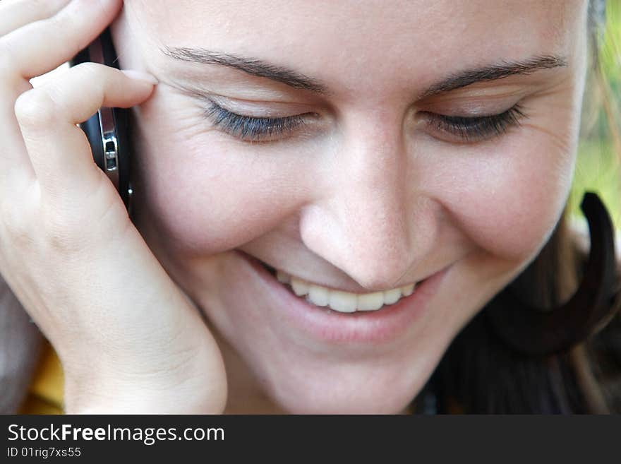 Portrait of Woman, who talks by mobile phone. Portrait of Woman, who talks by mobile phone