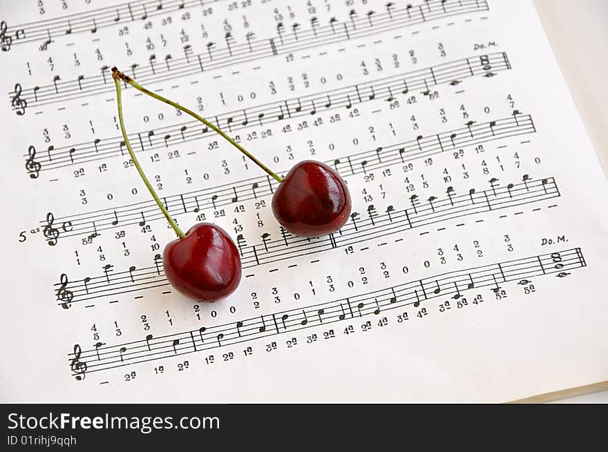 Two sweet cherries and notes book.