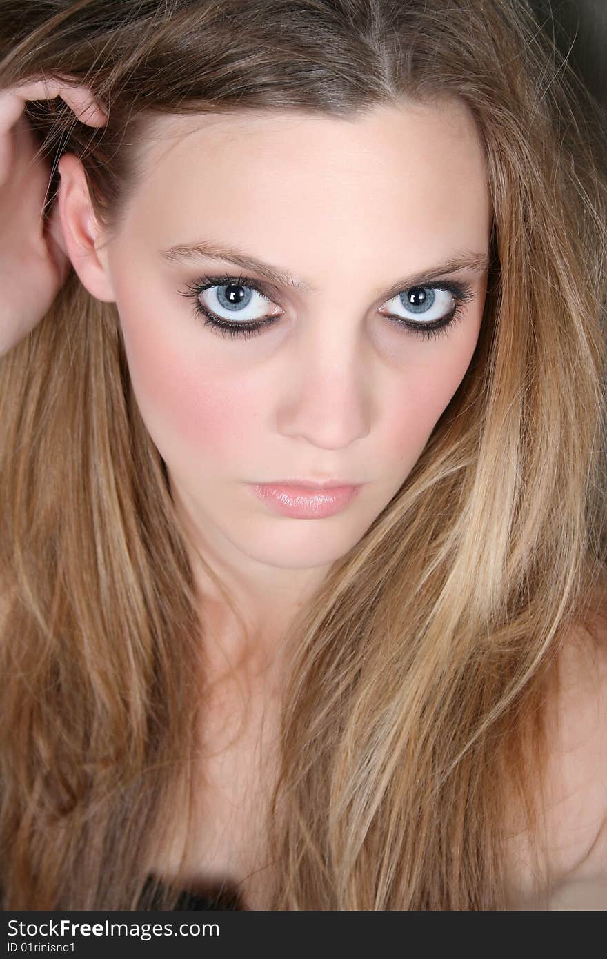 Beautiful female model with blue eyes and dark make up