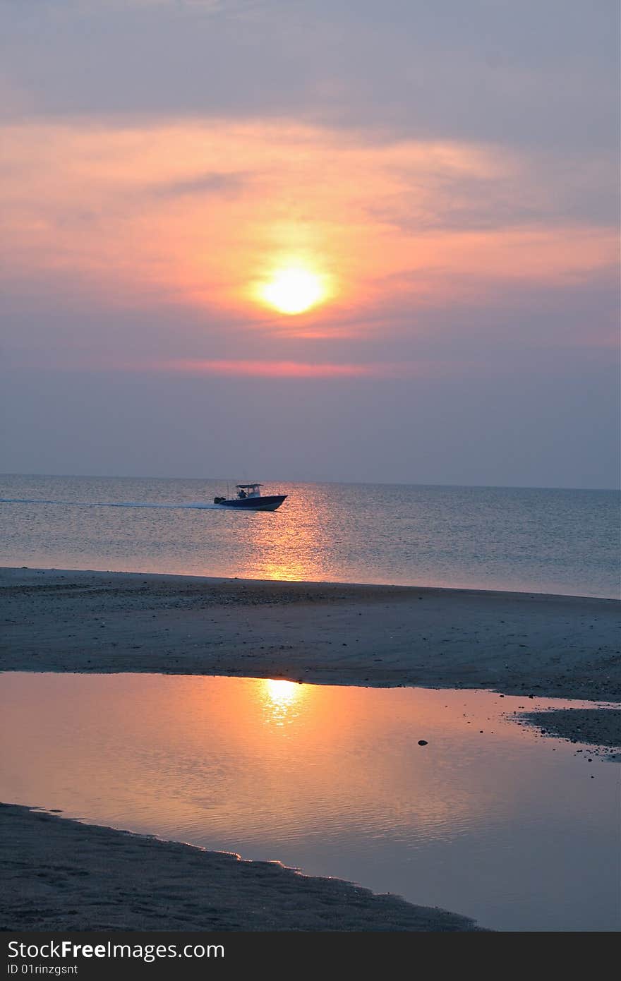 Boat traveling along the coast at sunrise. Boat traveling along the coast at sunrise