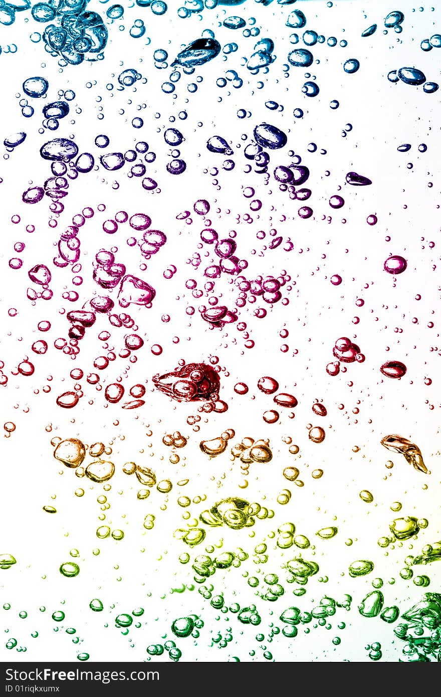 Macro of colorful air bubbles underwater against white background