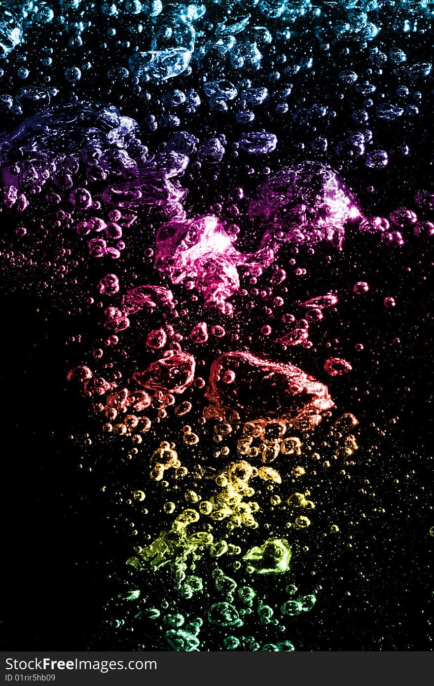 Macro of colorful air bubbles underwater against black background