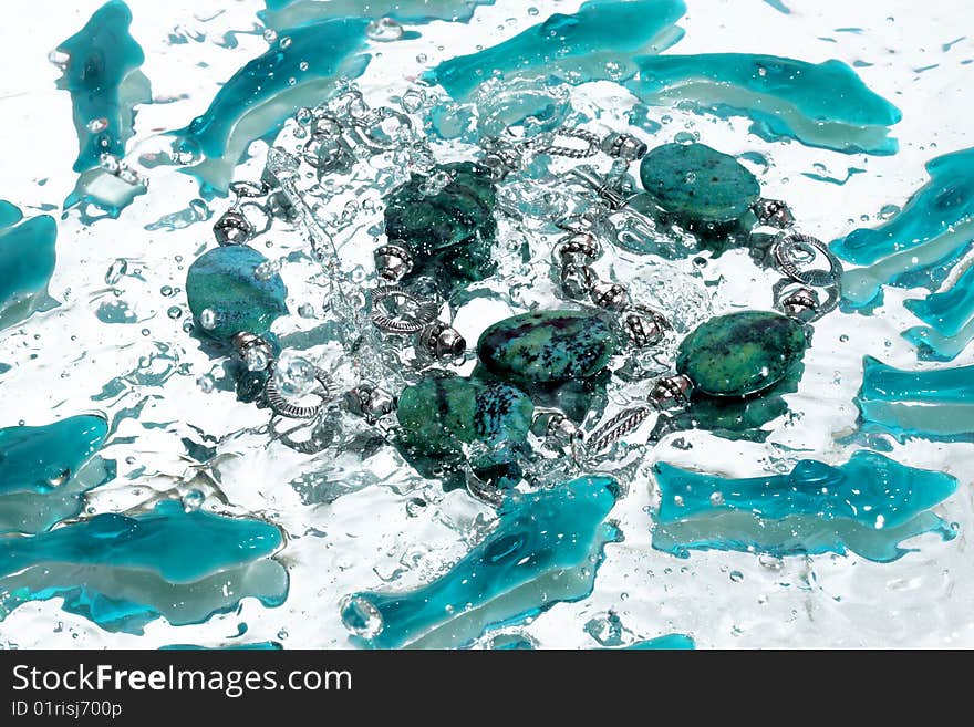 Azure necklace splash in water. Azure necklace splash in water