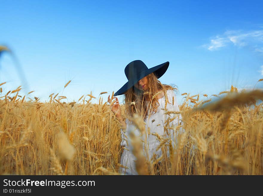 Woman with black hat in wheat field. Woman with black hat in wheat field