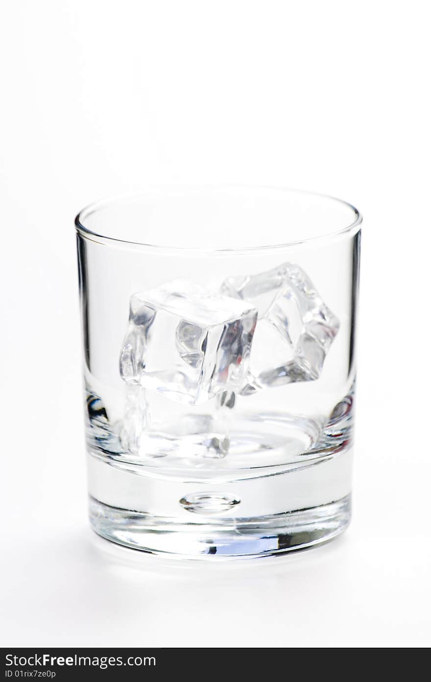 Alcoholic beverage whith ice cubes isolated over white