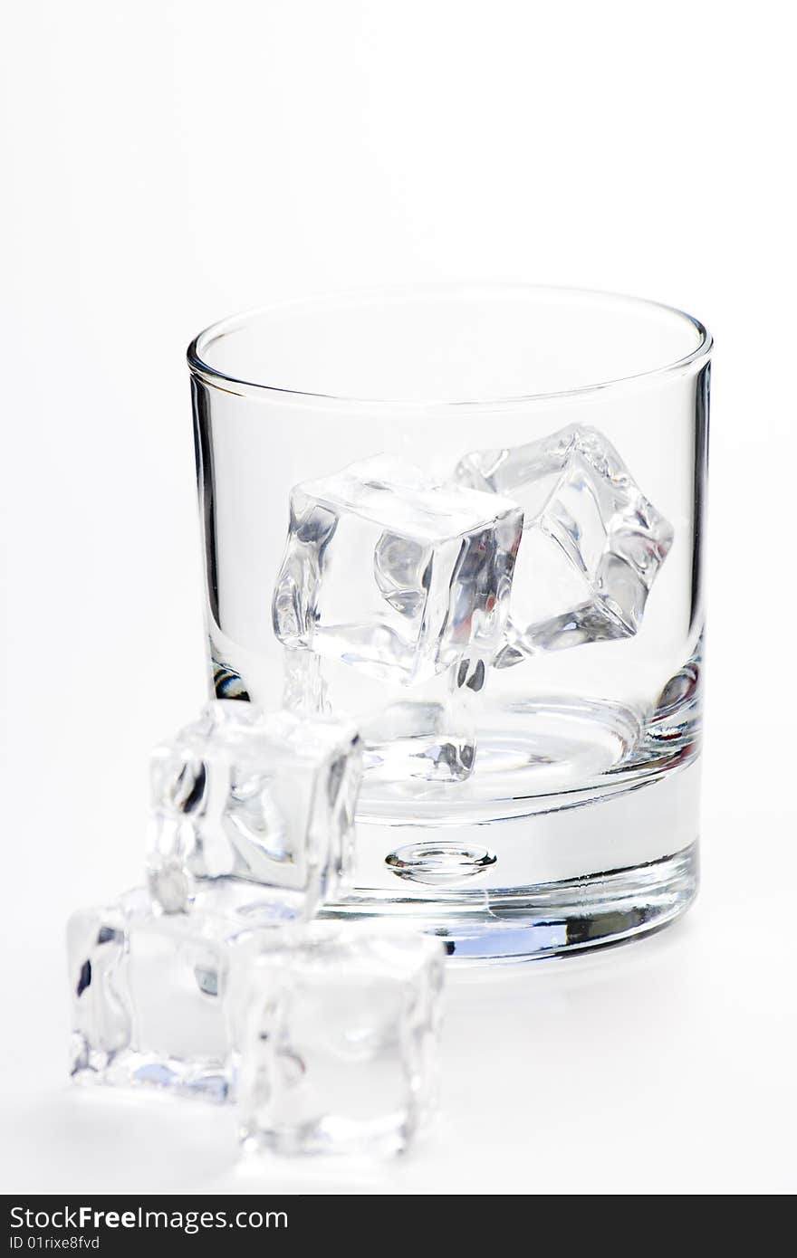 Alcoholic beverage whith ice cubes isolated over white