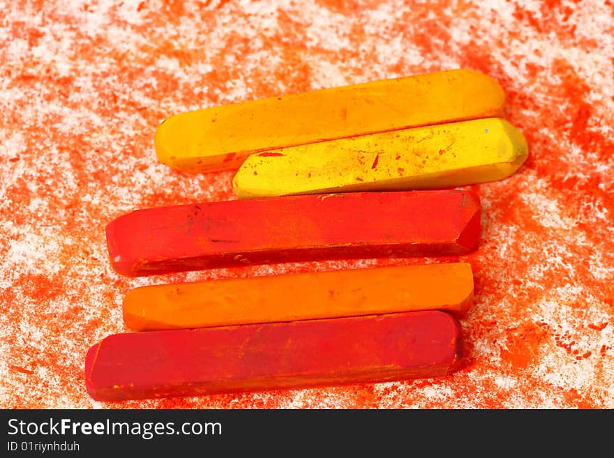 Red macro of pastel sticks isolated