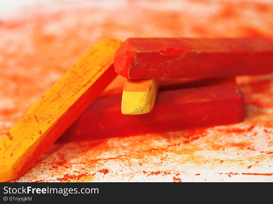 Red macro of pastel sticks isolated