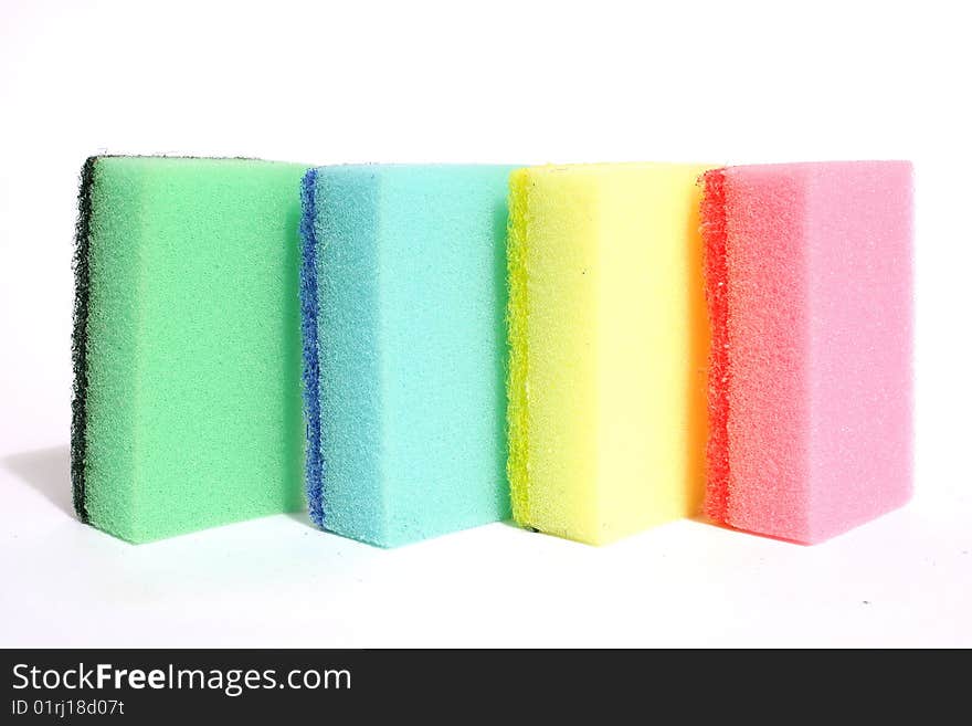 Synthetic sponge for washing dishes. Close-up, isolated on a white background. Synthetic sponge for washing dishes. Close-up, isolated on a white background.