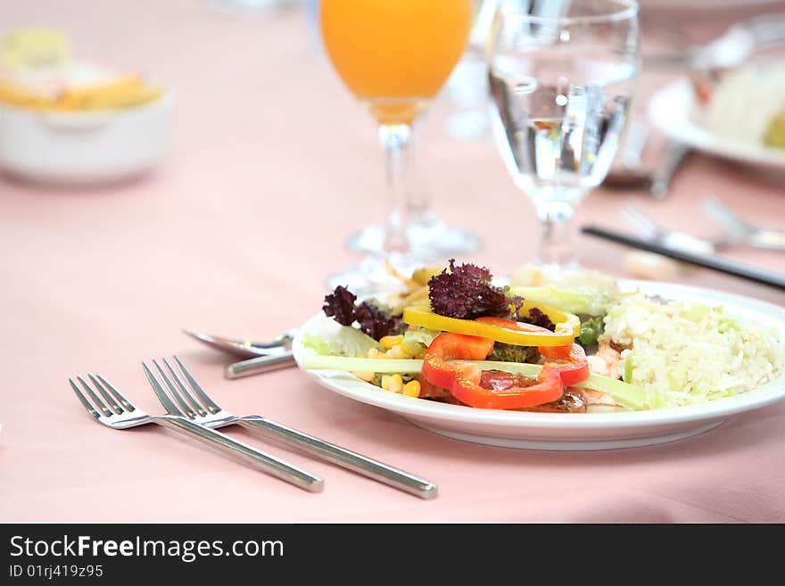 Lush healthy fresh salad on white plate with window light